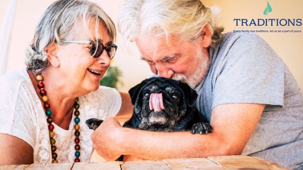Elderly couple enjoying time with their dog.